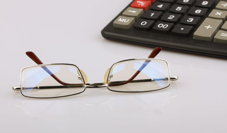 Business still-life of a eyeglasses, calculator