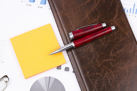 Business still-life of a charts, pen, sticker, card holderの写真素材