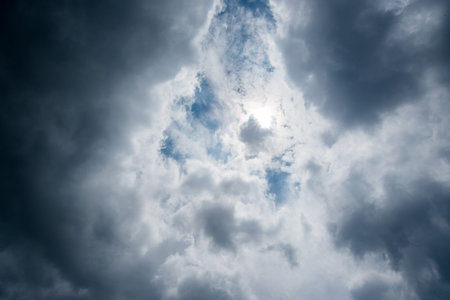 clouds with background,sunlight through very dark clouds background of dark storm clouds,black sky...
