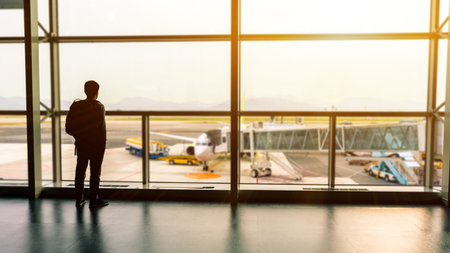 travel,Backpack tourists waiting flight on the gate in airport for summer trip.の写真素材