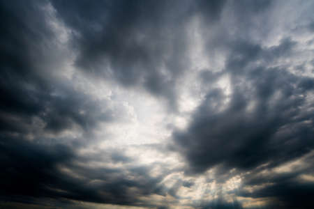 dark storm clouds,clouds with background,Dark clouds before a thunder-storm.の写真素材