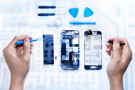 The smartphone was damages and need to repair  which tools smartphone that stand isolated on white background by hands of repairman.の写真素材