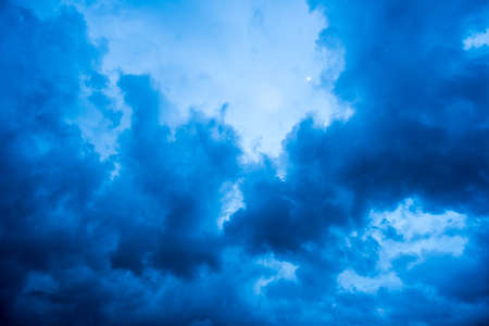 dark storm clouds with background,Dark clouds before a thunder-storm.の写真素材