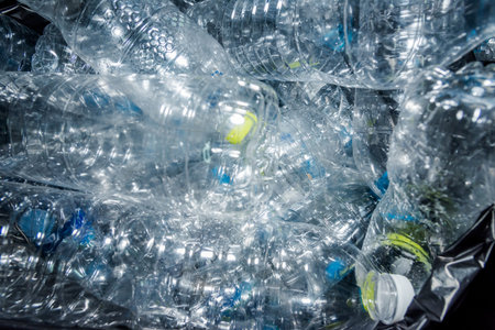 Plastic bottles in black garbage bags waiting to be taken to recycle.