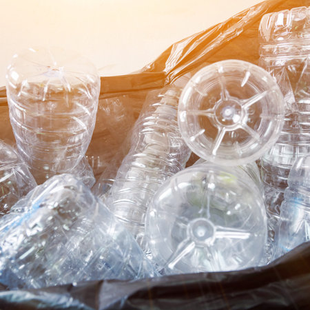 Plastic bottles in black garbage bags waiting to be taken to recycle.