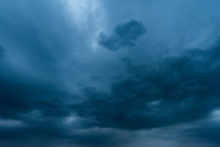 dark storm clouds with background,Dark clouds before a thunder-storm.の写真素材