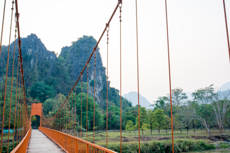 Orange bridge over song river Landmark in Vang Vieng,Laosの写真素材