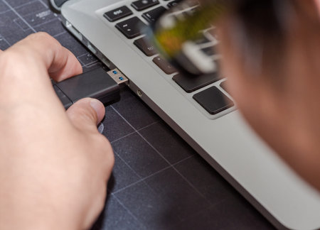 USB flash memory drive plugged into a computer laptop port.