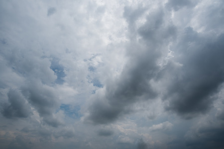 dark storm clouds with background,Dark clouds before a thunder-storm.の写真素材