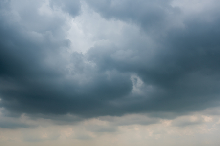 dark storm clouds with background,Dark clouds before a thunder-storm.の写真素材