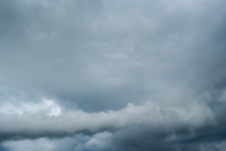 dark storm clouds with background,Dark clouds before a thunder-storm.の写真素材