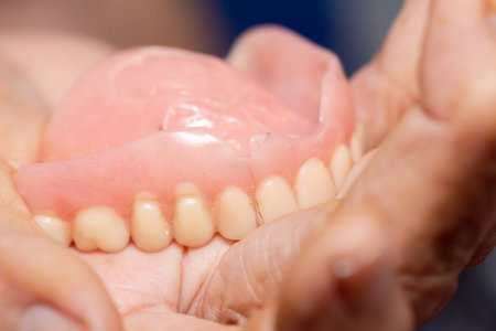 Old denture on a white background.