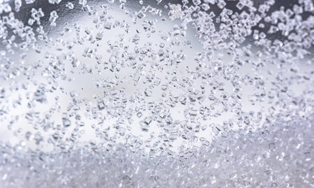Close up of crystal sugar in Glass bottles on white background.