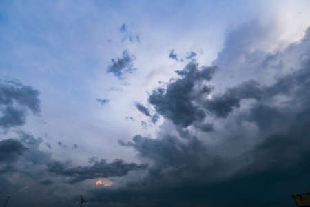 dark storm clouds with background,Dark clouds before a thunder-storm.の写真素材