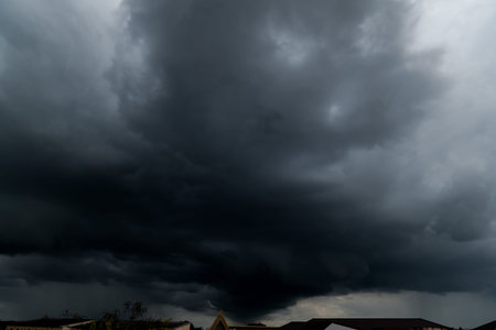 dark storm clouds with background,Dark clouds before a thunder-storm.の写真素材