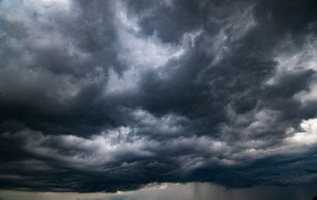 dark storm clouds with background,Dark clouds before a thunder-storm.の写真素材