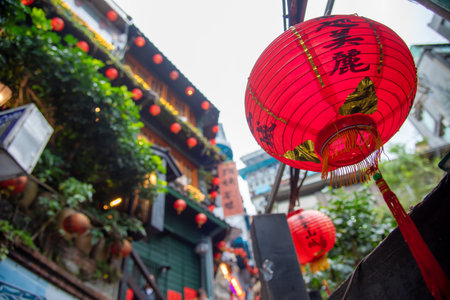 Traveller tourist hand holding smartphone while taking a photograph of jiufen Culture Village Taipei, Taiwan (Letters With Means Tea shop)の写真素材