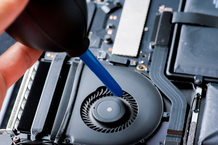 Cleaning and repairing the interior of a laptop.