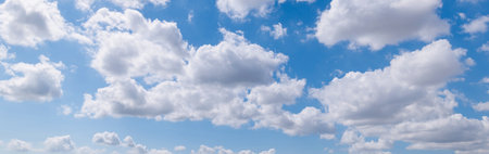 Panoramic view of clear blue sky and clouds, Blue sky background with tiny clouds. White fluffy clouds in the blue sky. Captivating stock photo featuring the mesmerizing beauty ofの写真素材