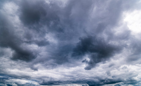 dark storm clouds with background,Dark clouds before a thunder-storm.の写真素材