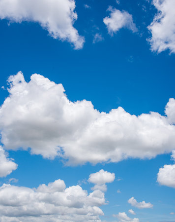 clear blue sky background,clouds with background, Blue sky background with tiny clouds. White fluffy clouds in the blue sky.の写真素材
