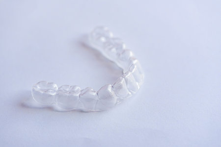 clear aligners device in the mouth on a white background. (invisalign)