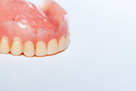 Old denture on a white background.
