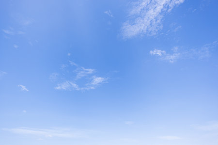 clear blue sky background,clouds with background, Blue sky background with tiny clouds. White fluffy clouds in the blue sky.の写真素材