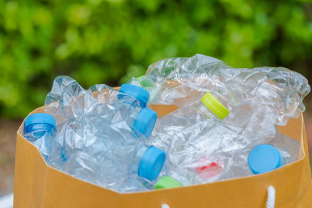 Plastic bottles in black garbage bags waiting to be taken to recycle.