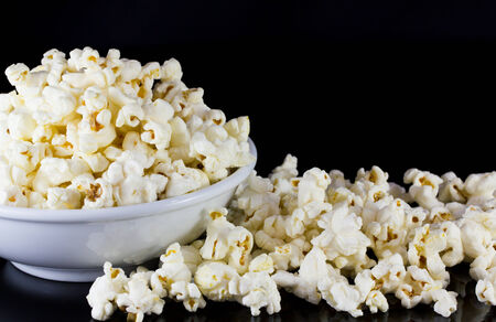 Popcorn in bowl isolate on blackの写真素材