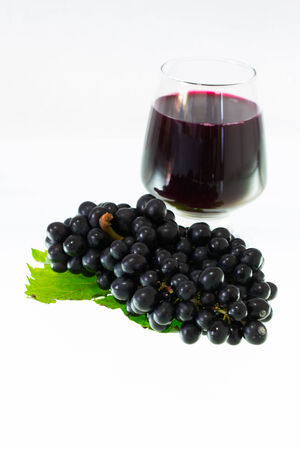 Ripe grapes and wine isolate on white backgroundの写真素材