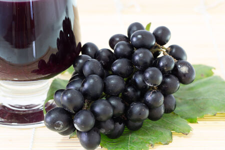 Ripe grapes and wine isolate on white backgroundの写真素材