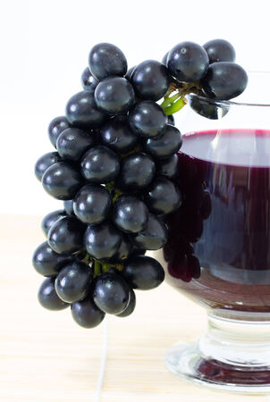 Ripe grapes and wine isolate on white backgroundの写真素材