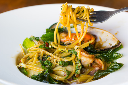 Spicy seafood spaghetti on dishの写真素材