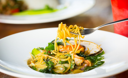 Spicy seafood spaghetti on dishの写真素材