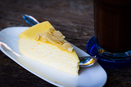 Cheesecake with white chocolate on dish on wood tableの写真素材