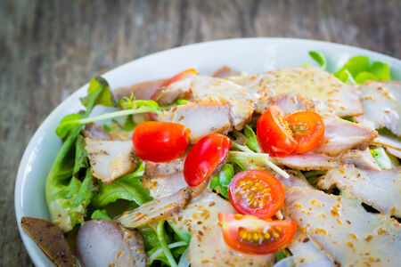 Roasted pork salad on plateの写真素材
