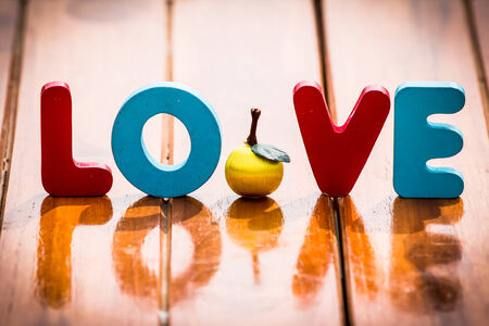 Colorful Wooden word love on wood tableの写真素材