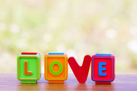 Colorful wooden and toy word love on meadow backgroundの写真素材