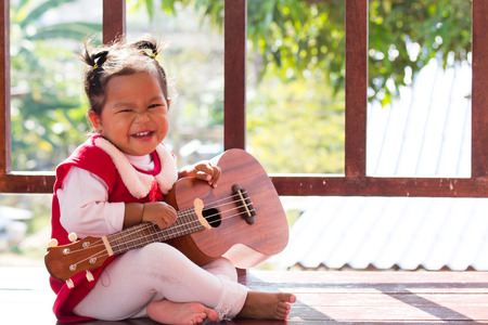 Cute little girl with ukuleleの写真素材