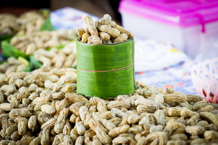 Peanuts in shell on banana leaf glass in market