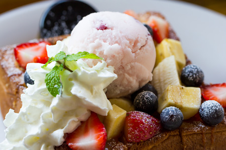 Honey toast with whipped cream,icecream and mix berryの写真素材