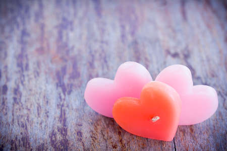 Candle heart shape on wood table in vintage styleの写真素材