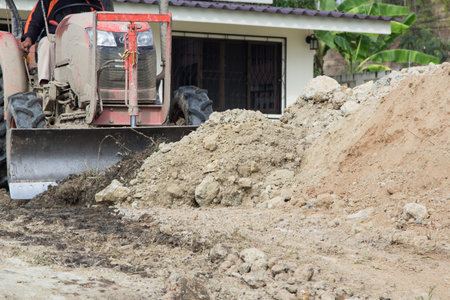 Steel wheeled compactor working the ground at a new housing development