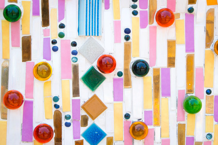 Colorful ceramic pattern decoration with pebbles and marble on the wallの写真素材