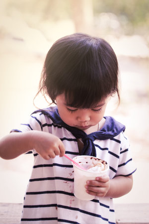 Cute little girl is eating icecream