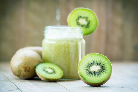 Piece of kiwi on kiwi juice backgroundの写真素材
