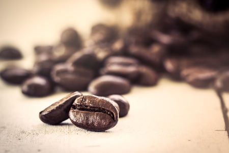 Roasted coffee bean on wooden background in vintage color styleの写真素材