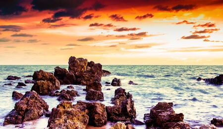 Rock in sea with wave on sunset  time,filtered color effectの写真素材