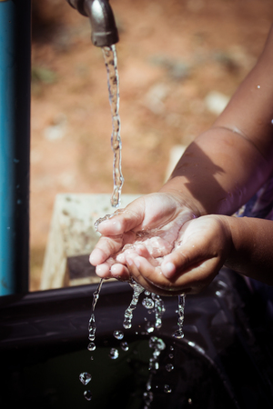 Washing of child hands under running waterの写真素材